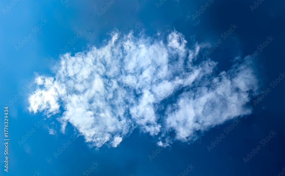 Naklejka premium A composite cloud of several wisps of rolling vapor. Wind flow forms a rain clouds that accumulates to the required critical mass. Beautiful seascape natural composition simple blue sky with steam.