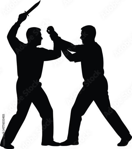 Silhouette of two men in a fight one holding a knife above his head