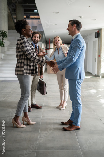 Diverse business people shaking hands making deal