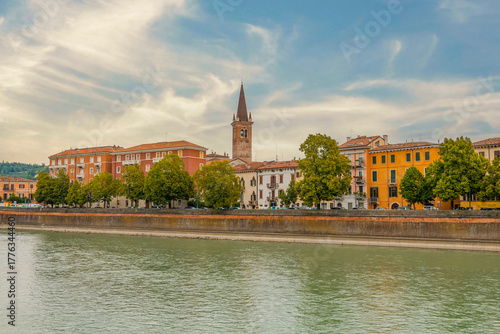 Fototapeta Naklejka Na Ścianę i Meble -  Verona, Italy, on a cloudy day, with historic streets, colorful buildings, and iconic landmarks under overcast skies, creating a moody yet charming city atmosphere