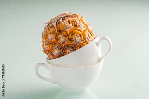 stacked coffee mugs with a pineapple close up in it