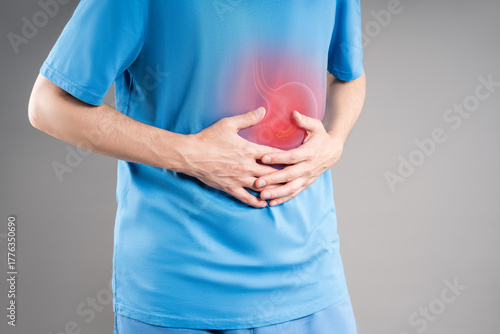 Stomach ulcer, bloating, man with abdominal pain, symptoms of gastritis, diseases of the digestive system