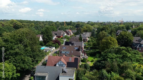 Wallpaper Mural High angle view flying over a suburban district in Hamburg, Germany. Rooftops of houses, lush green trees, and private gardens Torontodigital.ca