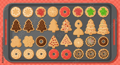 A baking sheet filled with a variety of decorated Christmas cookies.
