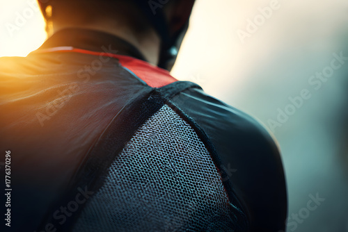 Athlete's Gaze: A cyclist's focused posture, a study in determination, framed against the soft glow of a competitive course ahead.