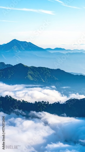 Wallpaper Mural Mountainscape's Mist: The majestic landscape unfolds with layers of mountains, enveloped in a soft, ethereal mist under a clear, bright sky. A symphony of nature's beauty and tranquility. Torontodigital.ca