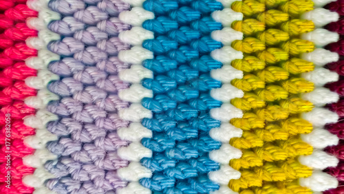 Pink, purple, blue, yellow, red, and white yarn background with a soft texture; yarn background.