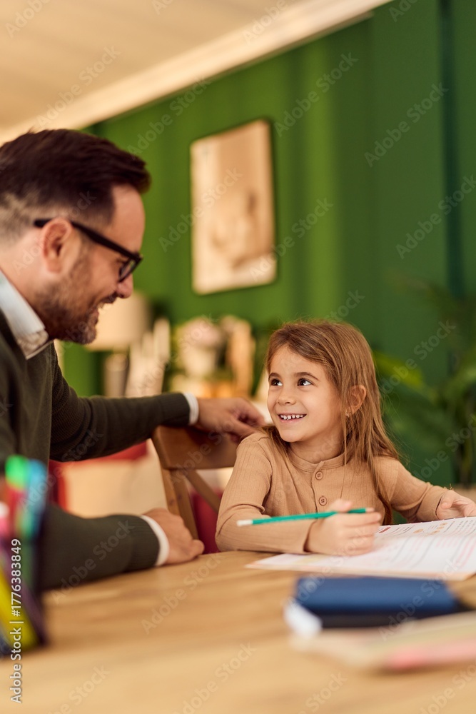 Fototapeta premium Father Helps Daughter With Homework At Home Study Table In Cozy Green Room