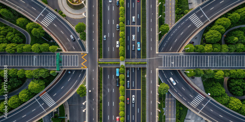Aerial view of highway interchange with lush greenery and multiple lanes, showcasing urban infrastructure and transportation