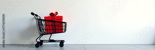 sleek black shopping cart parked front plain white wall minimalist red gift box bold sale signage amidst