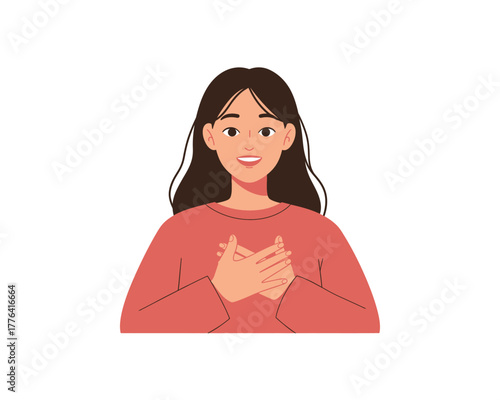 Young woman with brown hair and a warm smile holds her hands over her heart expressing gratitude and sincere emotion