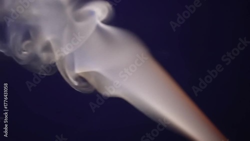 Smoke swirling in the air on dark background  