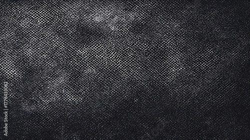 Close up view of a dark abstract textured surface featuring a repeating woven grid pattern overlaid with subtle white graininess and distressed splotches suitable for backgrounds