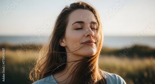 Woman closing eyes feeling wind on face symbolizing peace emotion and presence