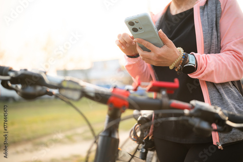 Woman Checking Bike Route On A Smartphone With Gps Map