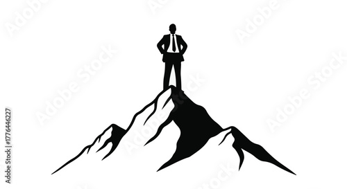 Silhouette of determined businessman standing triumphantly atop a mountain peak