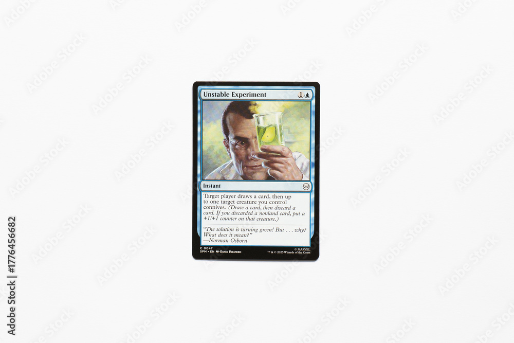Obraz premium Bradford, UK Nov 3 2025 Unstable Experiment card from the Spider-man magic the gathering card game shot isolated on a white paper background.