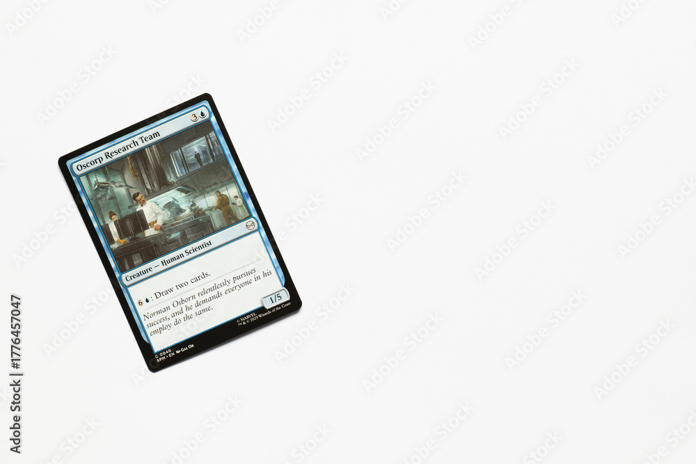 Obraz premium Bradford, UK Nov 3 2025 Oscorp Research Team card from the Spider-man magic the gathering card game shot isolated on a white paper background.