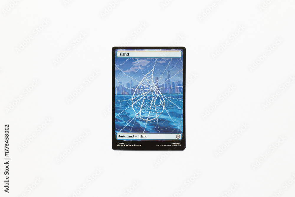 Obraz premium Bradford, UK Nov 3 2025 Basic Land Island card from the Spider-man magic the gathering card game shot isolated on a white paper background.