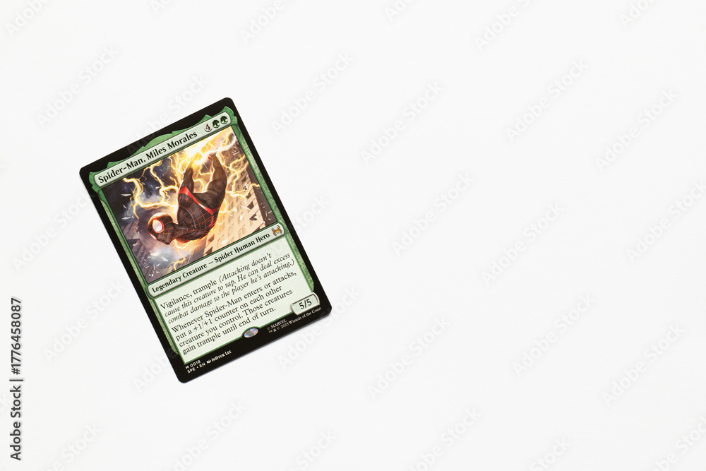 Naklejka premium Bradford, UK Nov 3 2025 Spider-man, Miles Morales card from the Spider-man magic the gathering card game shot isolated on a white paper background.