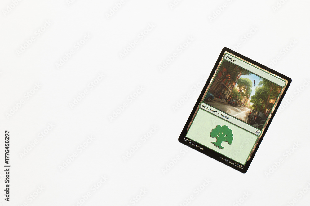 Obraz premium Bradford, UK Nov 3 2025 Forest basic land card from Spider-man magic the gathering game shot isolated on a white paper background.