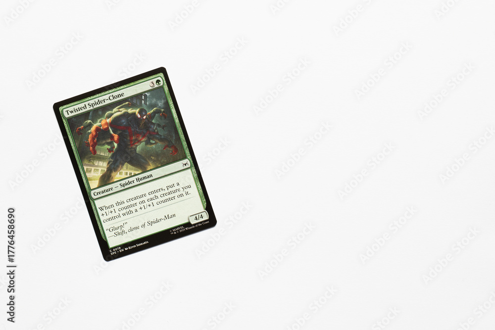 Naklejka premium Bradford, UK Nov 3 2025 Twisted Spider-clone card from Spider-man magic the gathering game shot isolated on a white paper background.