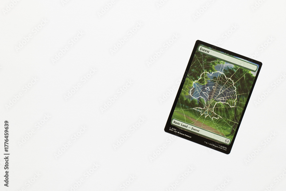 Naklejka premium Bradford, UK Nov 3 2025 Forest, basic land card from Spider-man magic the gathering card game shot isolated on a white paper background.