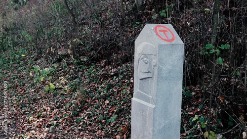 Details with a Via Transilvanica stone pillar in a forest in Romania.