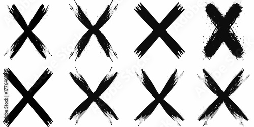 Collection of eight diverse black brush stroke x marks on white background
