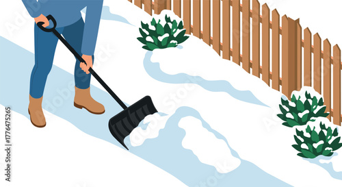 Winter snow removal in suburban backyard with shovel and wooden fence