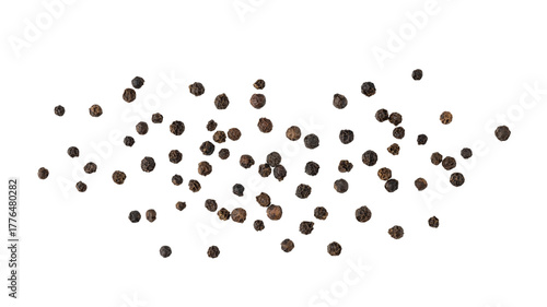 Dried black pepper berries closeup flying isolated on white background. Aromatic spicy ingredient for cuisine.