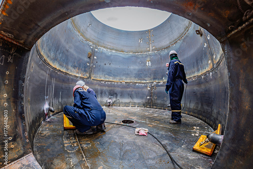 Male worker inspection vacuum test bottom plate tank petrochemical steel weld