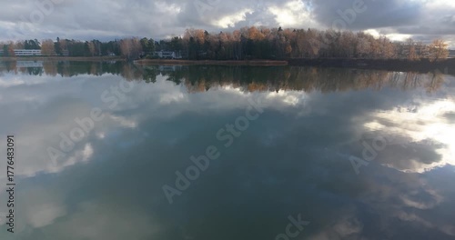 Drone flight from low over water rising vertically toward Helsinki horizon