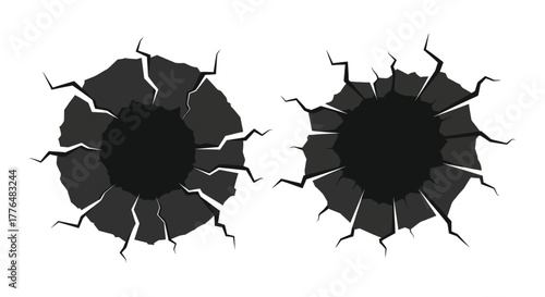 Two circular holes with cracked edges on a white background