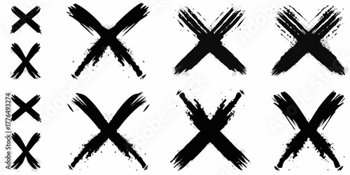 Collection of black brush stroke x marks with distressed edges on white background