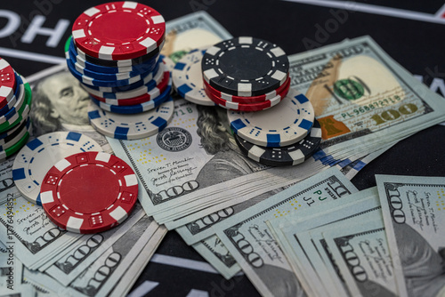 Stacks of colorful poker chips and US dollars showing casino wealth, risk, gambling and money winnings
