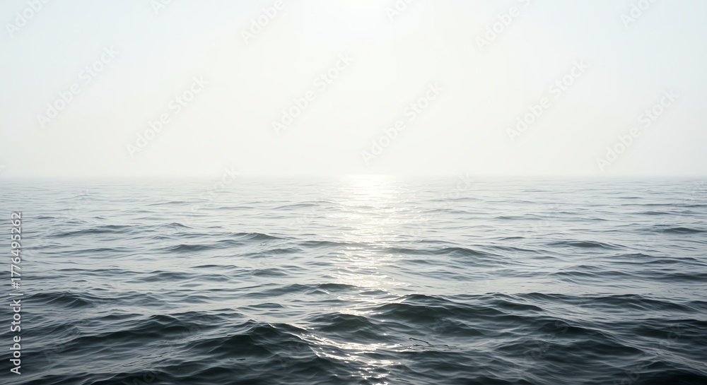 Fototapeta premium Ocean surface reflecting sunlight with hazy horizon