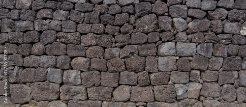 A volcanic stone wall stands with timeless texture