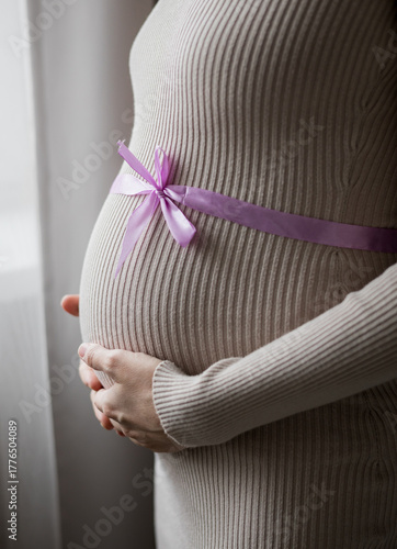 pregnant woman holding her belly