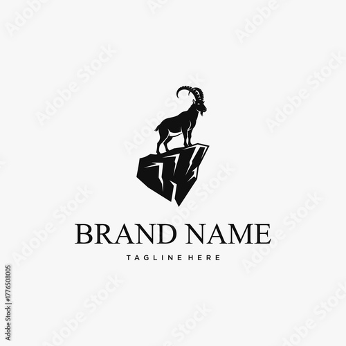 Silhouette of a majestic ibex standing proudly on a rugged mountain peak, symbolizing strength and resilience.