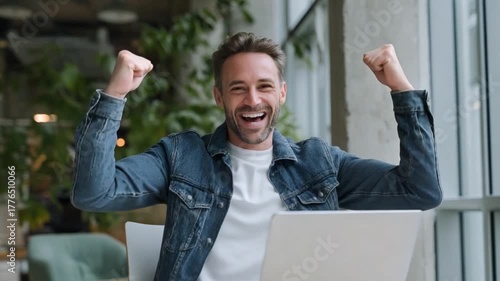 Triumph in Digital Space: A man celebrates a personal victory in the digital sphere, his face alight with excitement and the promise of success