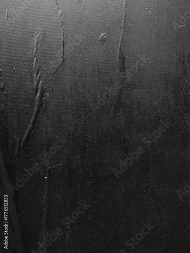 A vertical black poster with crease lines, a texture reminiscent of a wheatpaste street poster.