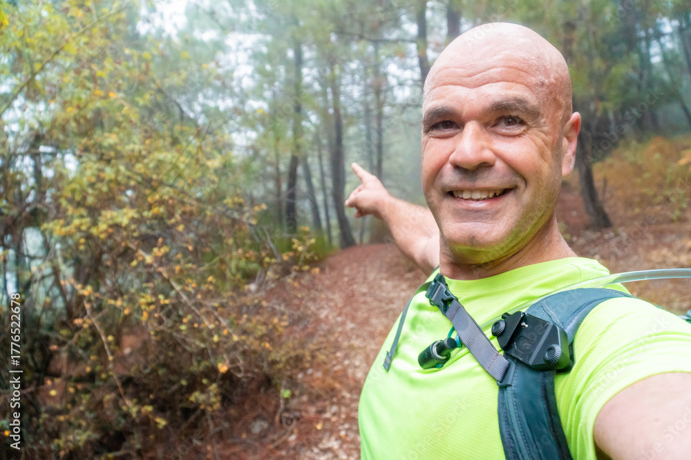Fototapeta premium Happy man takes a selfie in the forest. 