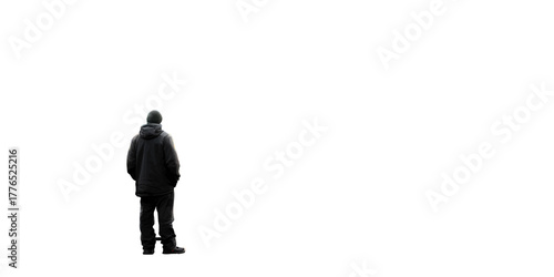Solitary man standing alone in the dark, contemplating life and future, wearing a winter coat and beanie Concept of loneliness, introspection, and the human condition