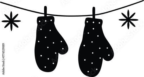 Pair of mittens hanging on a clothesline with snowflakes silhouette vector illustration