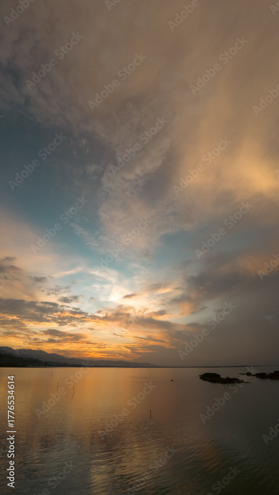 Fototapeta premium Dramatic Sunset Over Still Lake Water