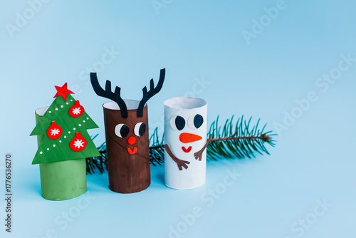 Christmas toy from toilet tube roll, paper toy santa claus, snowman, reindeer, tree rabbit on yellow background. Holiday easy kids DIY, decoration idea for winter season, home party. Children's crafts