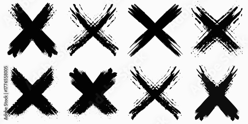 Collection of eight black grunge brush stroke x marks on a white background