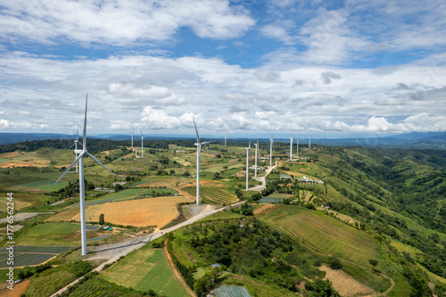 Wind turbines on Khao Kho mountain in Phetchabun, Thailand — renewable energy farm with scenic landscape and cloudy sky.