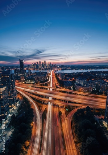 Aerial Long Exposure of Highway Interchange at Dusk With City Skyline View